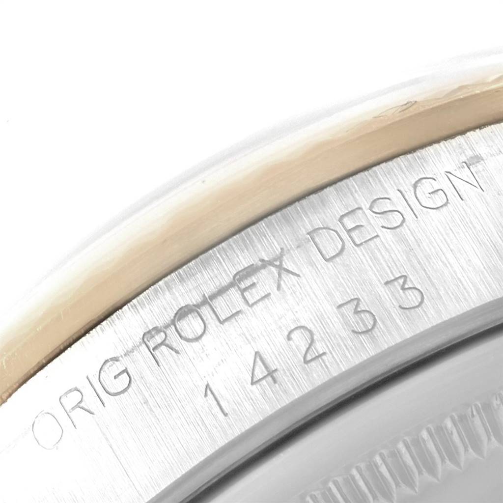 This close-up image shows the engraved inner bezel of a Rolex Oyster Perpetual 14233 Men's Steel and Gold (two tone) Grey Dial 14233 Men's Steel and Gold (two tone) Grey Dial watch.
