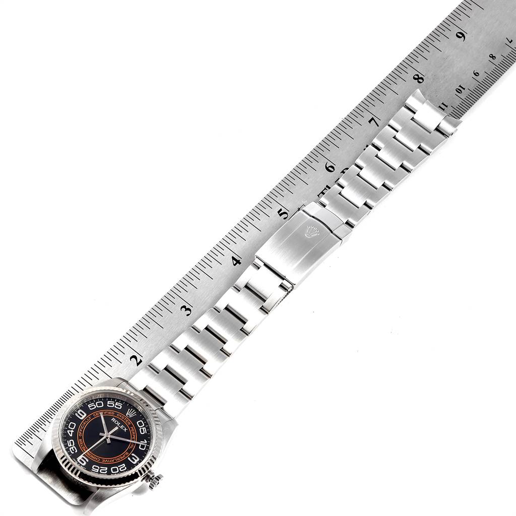 The image shows a Rolex Oyster Perpetual 116034 Men's Stainless Steel Black Dial 116034 Men's Stainless Steel Black Dial watch laid flat beside a ruler, highlighting the dial and bracelet.