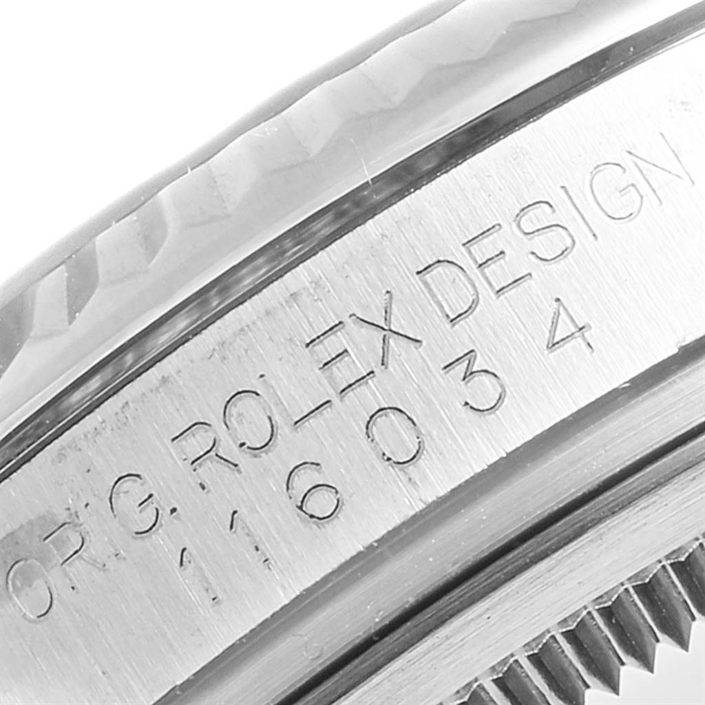 This close-up angle showcases the engraved inner bezel of a Rolex Oyster Perpetual 116034 Men's Stainless Steel Black Dial 116034 Men's Stainless Steel Black Dial watch.