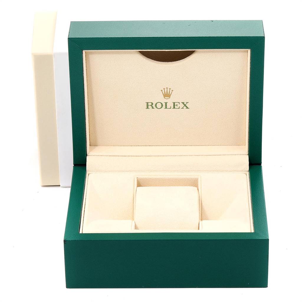 This image shows an open presentation box for the Rolex Oyster Perpetual 114200 Men
s Stainless Steel Champagne Dial 114200 Men
s Stainless Steel Champagne Dial watch, displaying its interior padding and the Rolex logo.