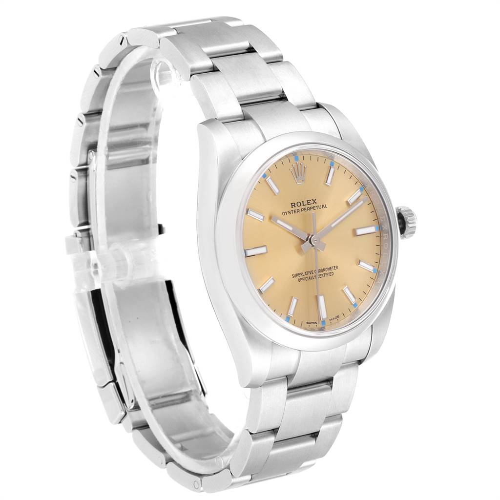 The image shows a Rolex Oyster Perpetual 114200 Men
s Stainless Steel Champagne Dial 114200 Men
s Stainless Steel Champagne Dial watch from an angle highlighting its bracelet, case, crown, and dial.