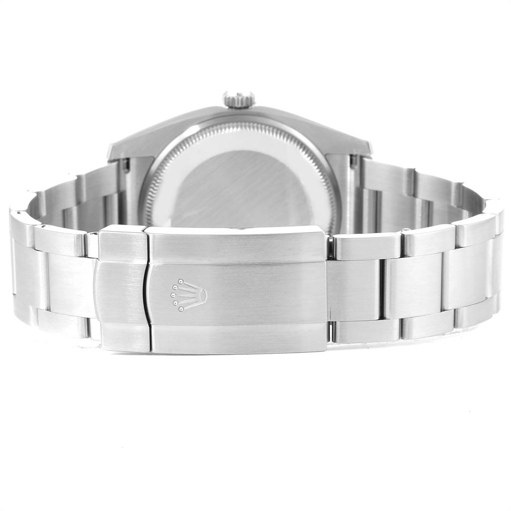 The image shows the back view of a Rolex Oyster Perpetual 114200 Men
s Stainless Steel Champagne Dial 114200 Men
s Stainless Steel Champagne Dial watch, focusing on the case back and bracelet clasp.