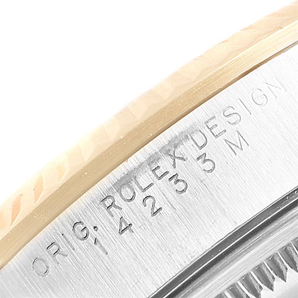 This close-up image shows the engraved case back of the Rolex Oyster Perpetual 14233 Men's Steel and Gold (two tone) Grey Dial 14233 Men's Steel and Gold (two tone) Grey Dial watch model.