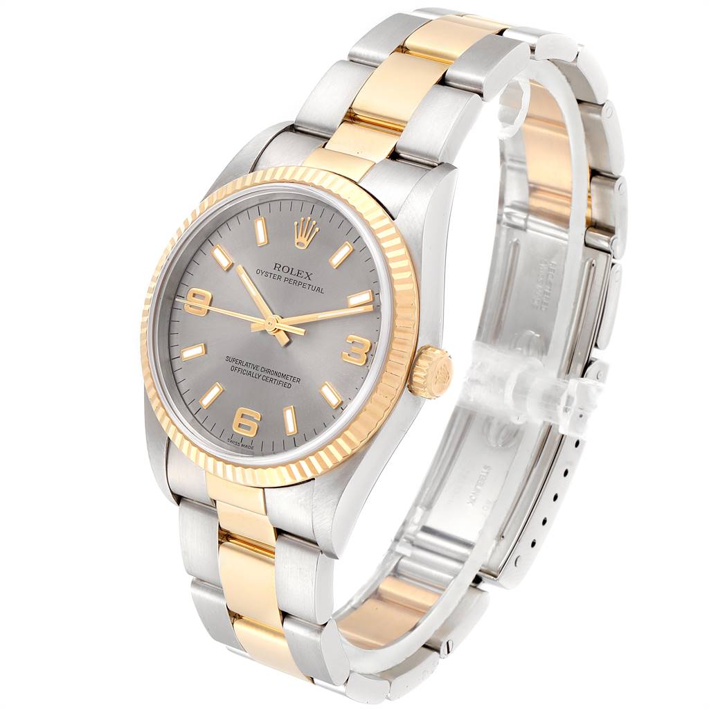 This Rolex Oyster Perpetual 14233 Men's Steel and Gold (two tone) Grey Dial 14233 Men's Steel and Gold (two tone) Grey Dial watch is shown from a three-quarter angle, highlighting its face, bezel, and bracelet.
