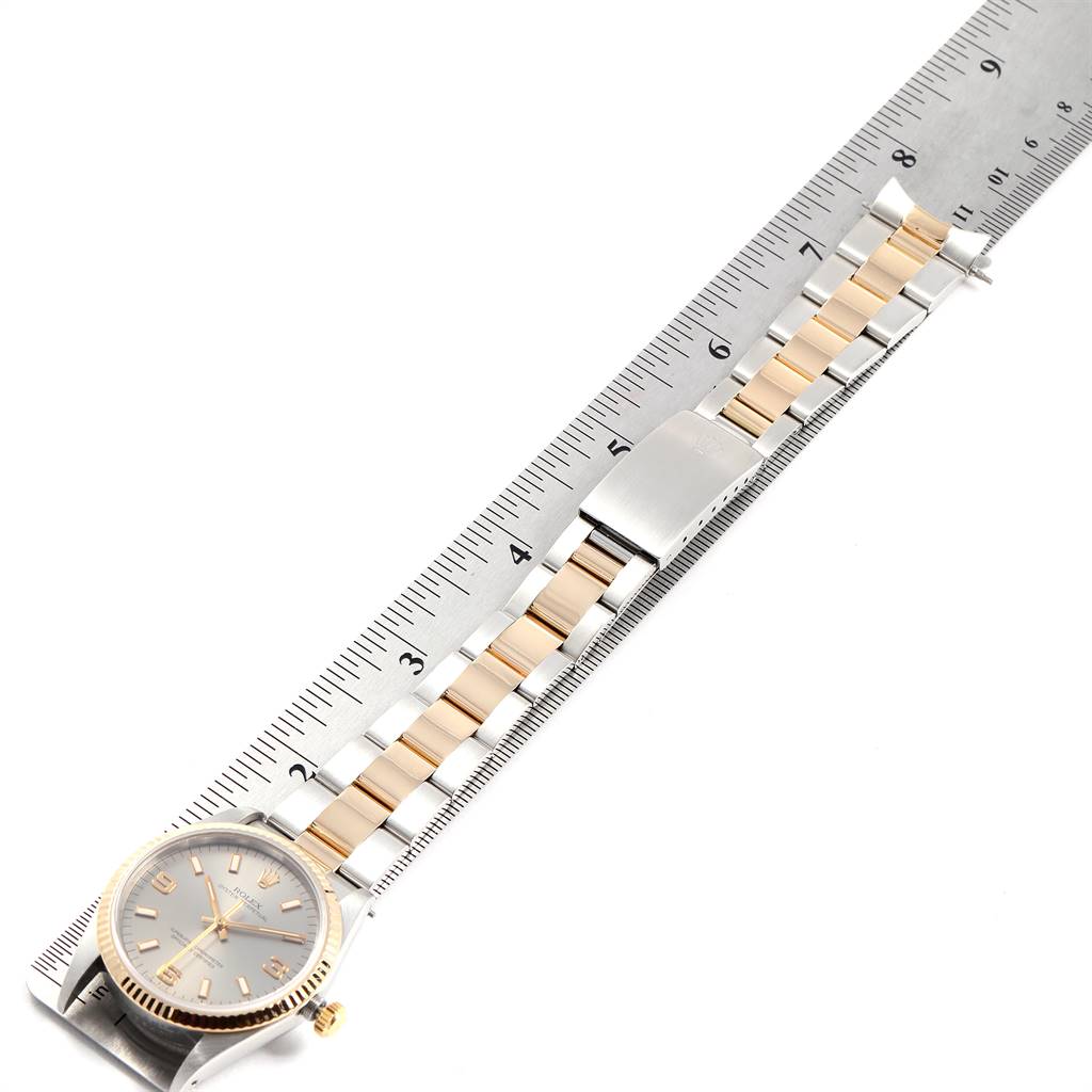 The image shows a Rolex Oyster Perpetual 14233 Men's Steel and Gold (two tone) Grey Dial 14233 Men's Steel and Gold (two tone) Grey Dial watch laid flat with its bracelet aligned with a ruler.