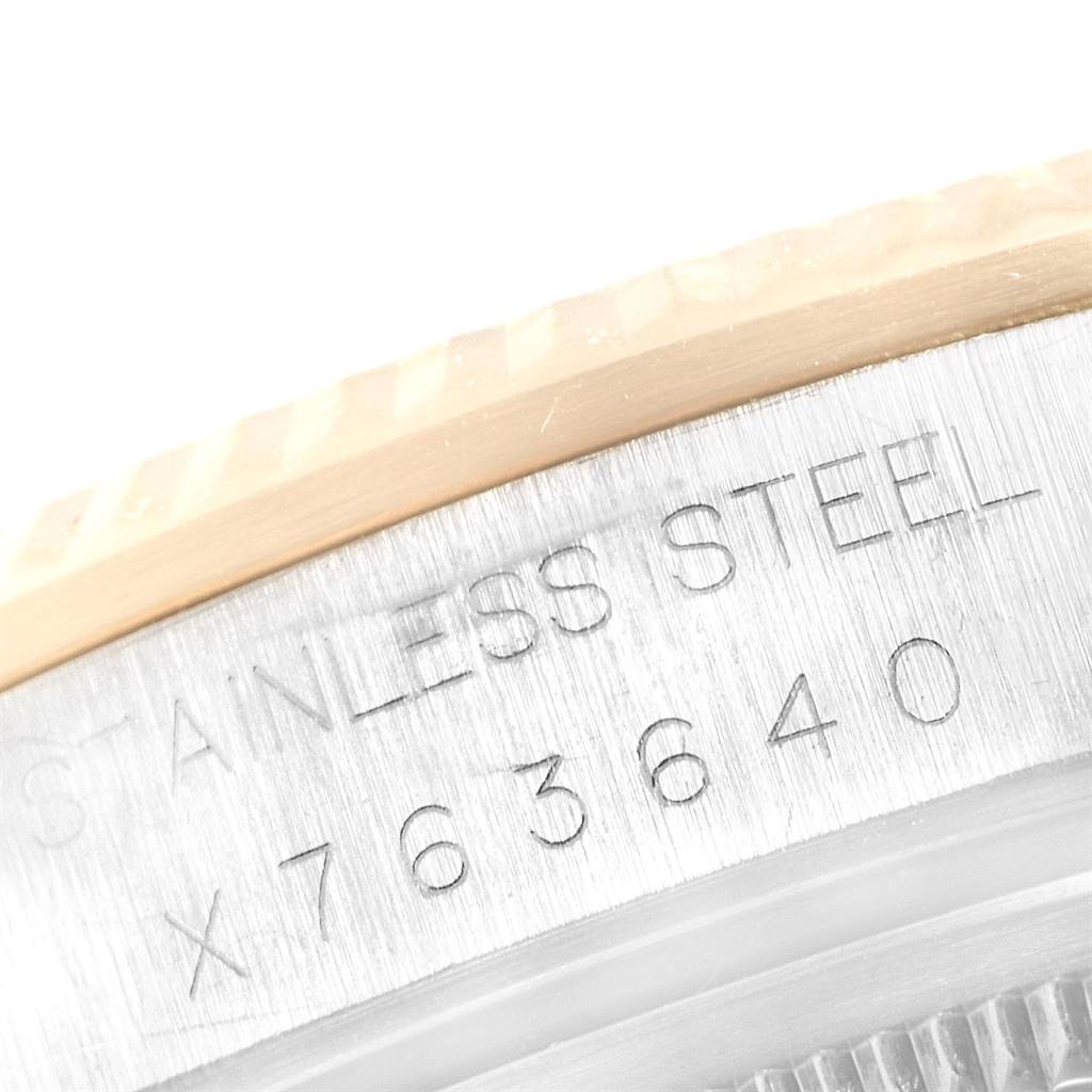 This image shows a close-up angle of the case back edge of a Rolex Oyster Perpetual 14233 Men's Steel and Gold (two tone) Grey Dial 14233 Men's Steel and Gold (two tone) Grey Dial watch, highlighting the stainless steel engraving and part of the fluted bezel.
