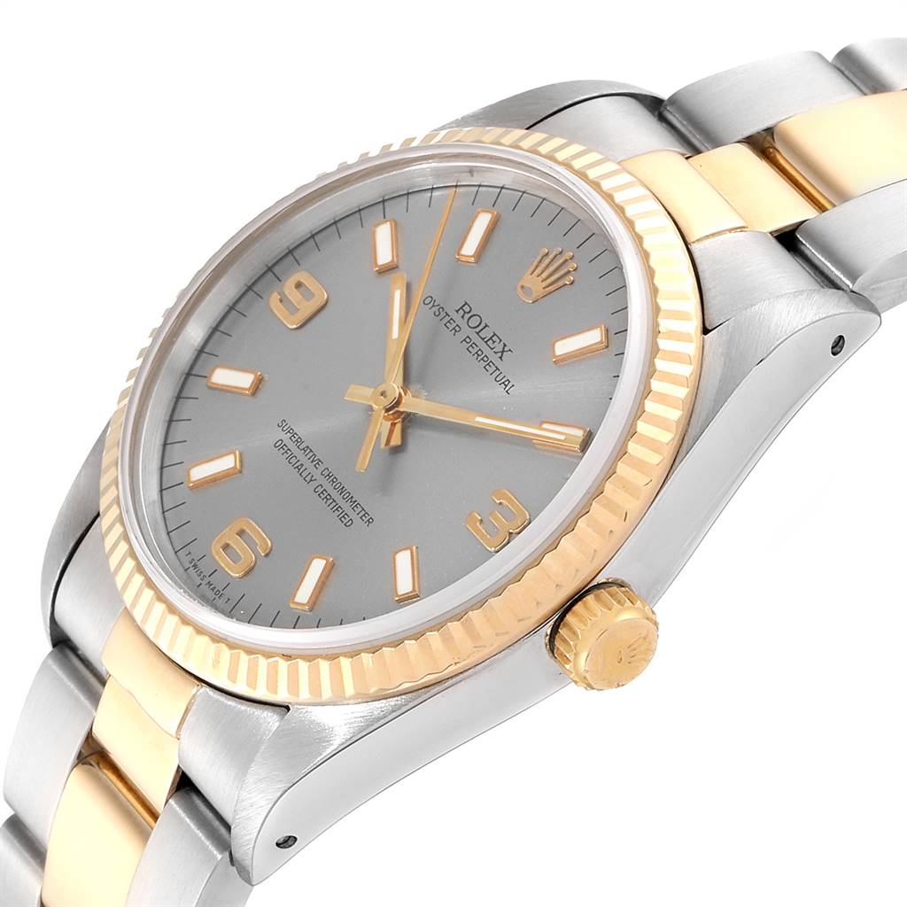 The Rolex Oyster Perpetual 14233 Men's Steel and Gold (two tone) Grey Dial 14233 Men's Steel and Gold (two tone) Grey Dial watch is shown at a slight side angle featuring its bezel, crown, dial, and bracelet.