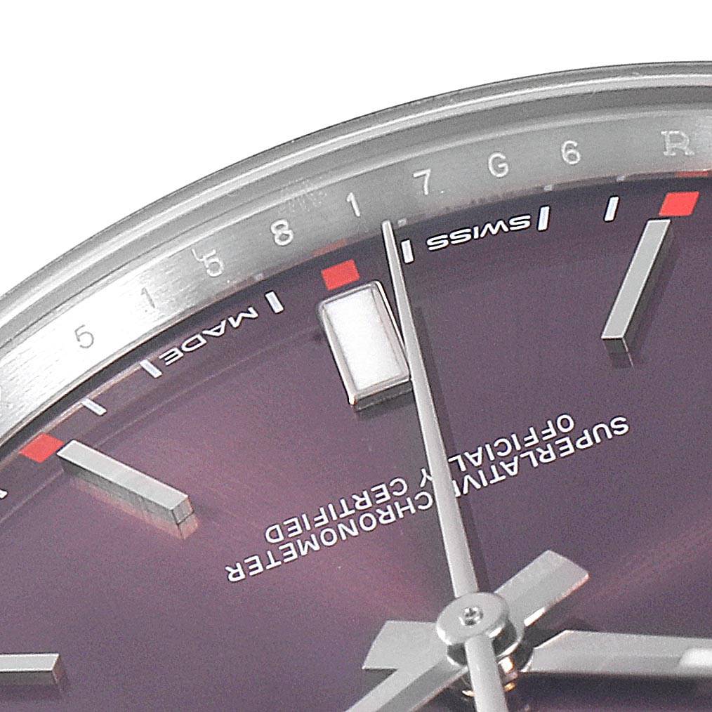 The image shows a close-up of the Oyster Perpetual model by Rolex, highlighting the upper half of the dial and markers.