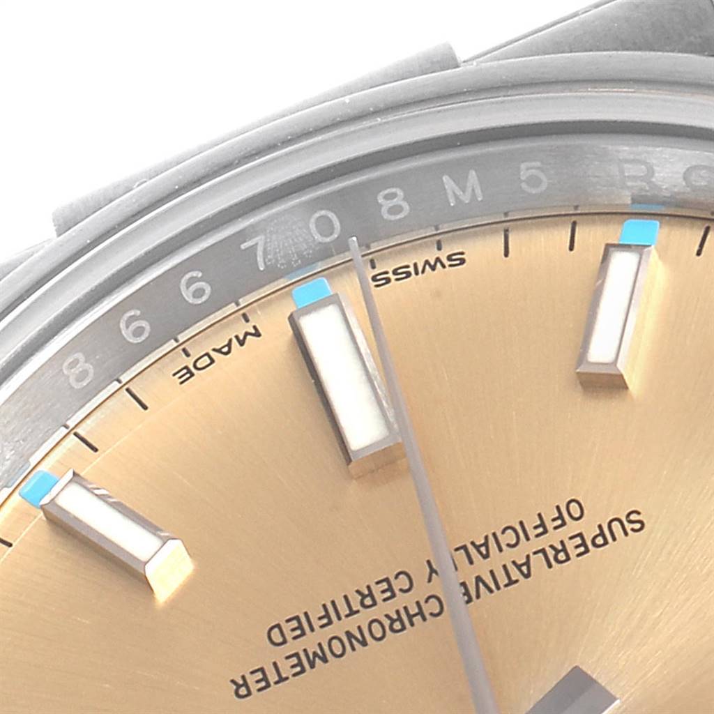 The close-up image shows the dial, markers, and part of the bezel of the Rolex Oyster Perpetual 114200 Men
s Stainless Steel Champagne Dial 114200 Men
s Stainless Steel Champagne Dial watch.