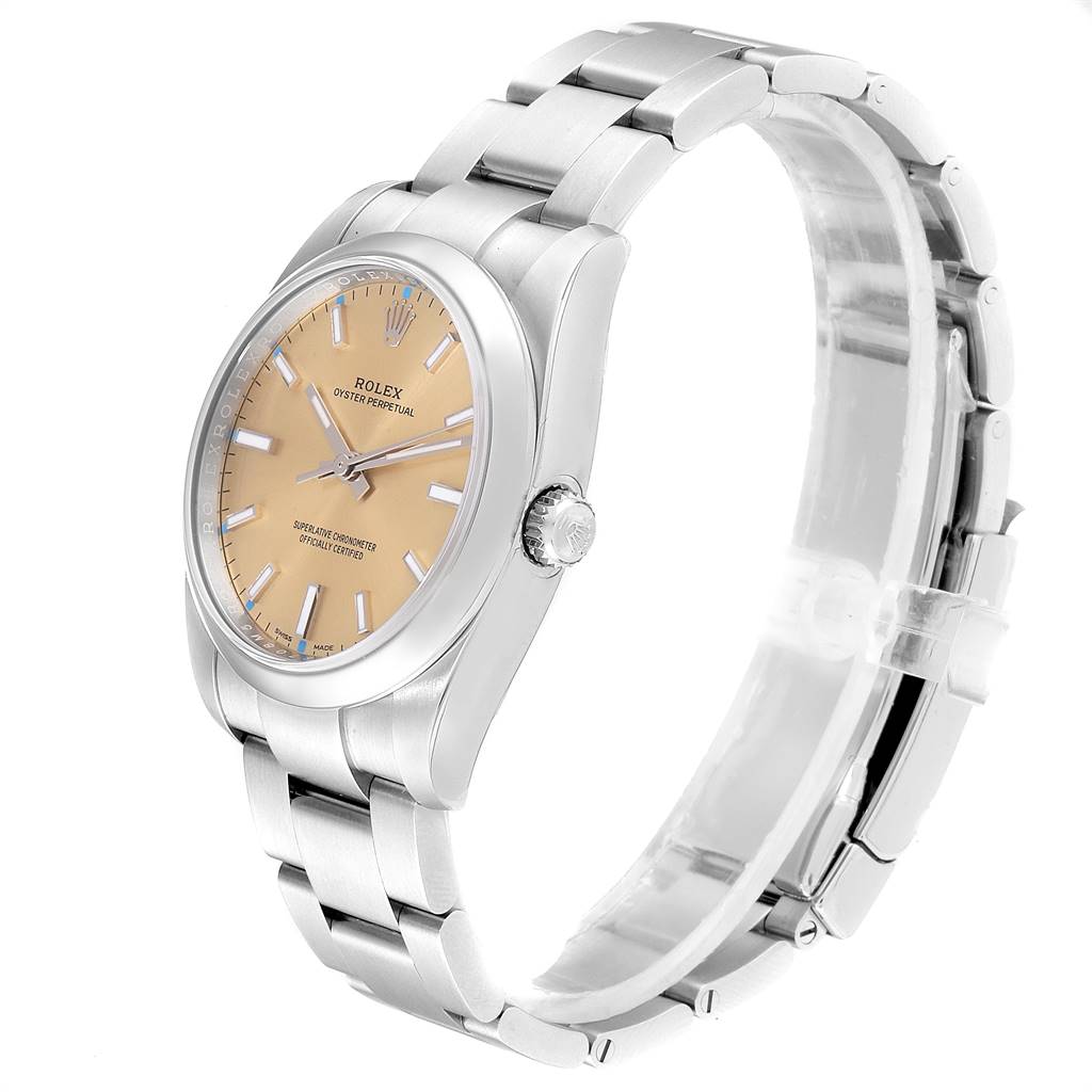 This image shows a Rolex Oyster Perpetual 114200 Men
s Stainless Steel Champagne Dial 114200 Men
s Stainless Steel Champagne Dial watch viewed at a 3/4 angle from the front, displaying its face, case, crown, and bracelet.
