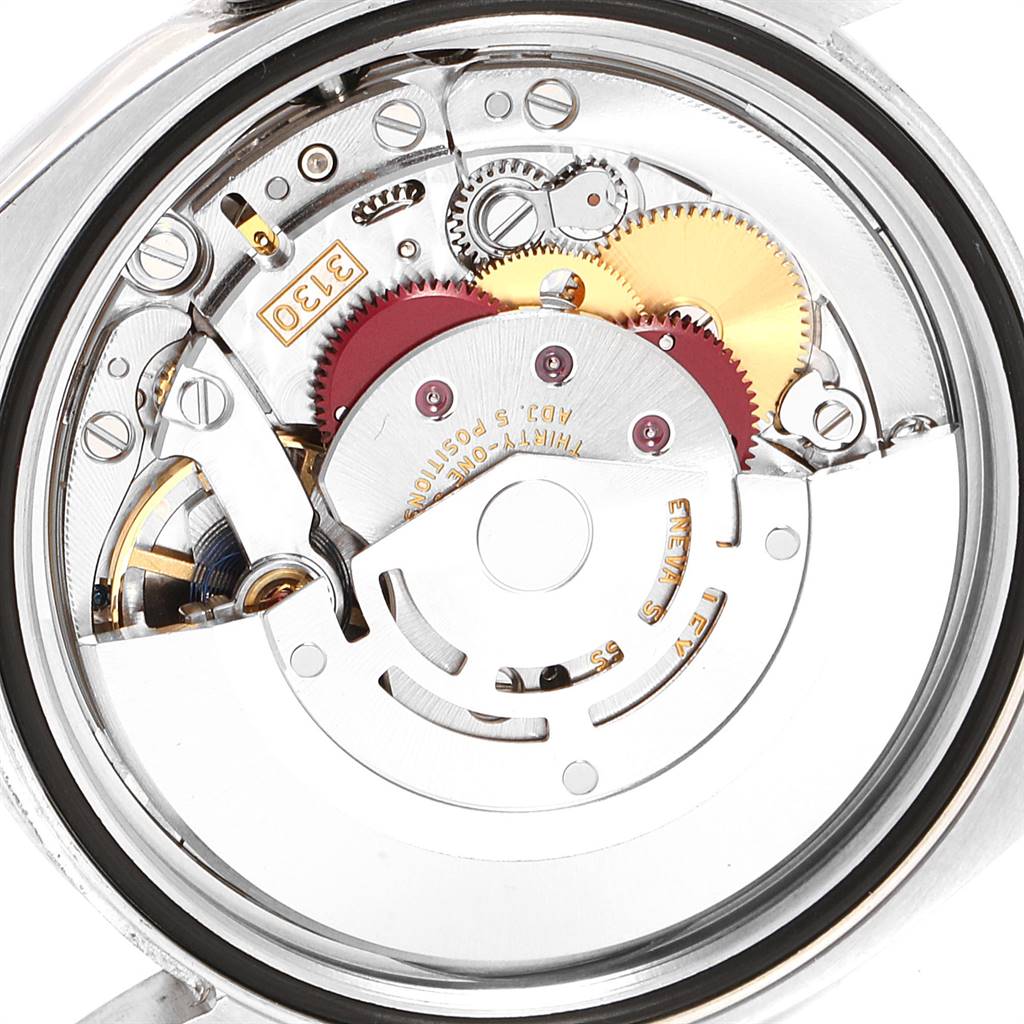 This image shows the internal mechanism of a Rolex Oyster Perpetual 116000 Men's Stainless Steel Champagne Dial 116000 Men's Stainless Steel Champagne Dial watch from the back, revealing gears and movement components.