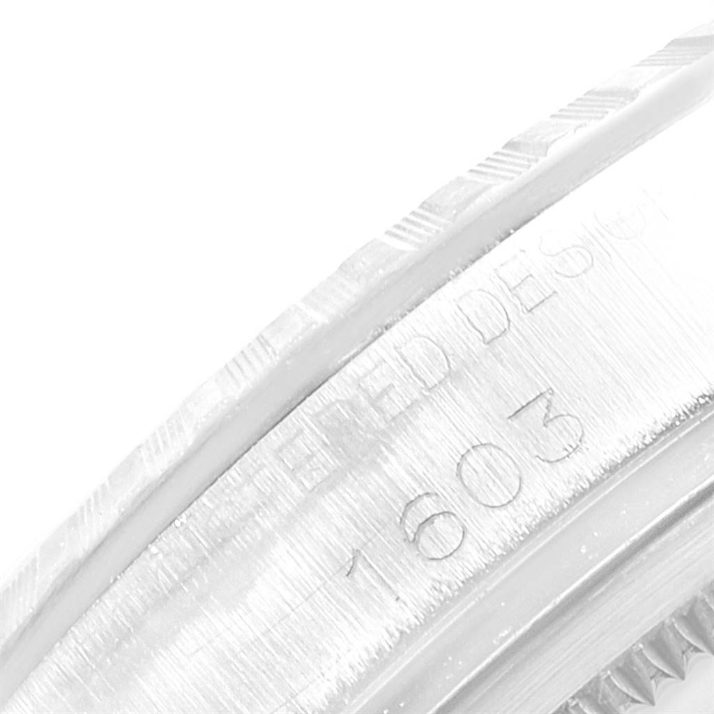 This close-up image shows the model number and part of the bezel of the Rolex Oyster Perpetual 1603 Men
s Stainless Steel Silver Dial 1603 Men
s Stainless Steel Silver Dial watch.