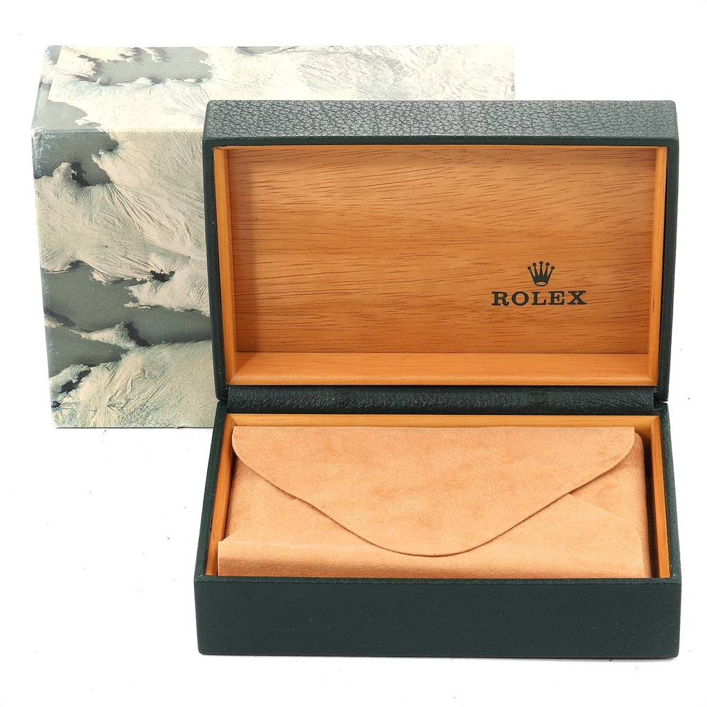 The image shows an open Rolex Oyster Perpetual 1603 Men
s Stainless Steel Silver Dial 1603 Men
s Stainless Steel Silver Dial watch box, displaying its wooden interior and a tan leather pouch.