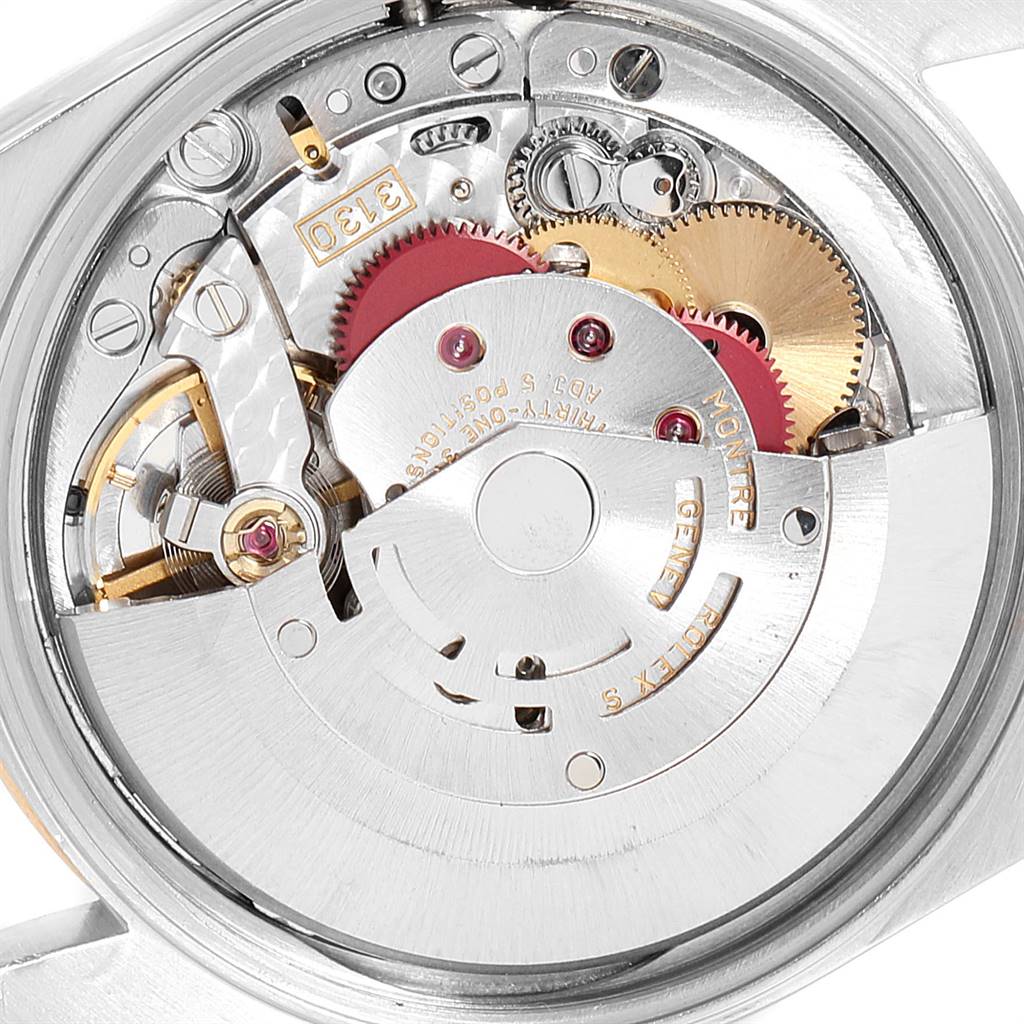The image shows a close-up of the internal movement mechanism of a Rolex Oyster Perpetual 14233 Men's Steel and Gold (two tone) Blue Dial 14233 Men's Steel and Gold (two tone) Blue Dial watch, including gears and rotors.