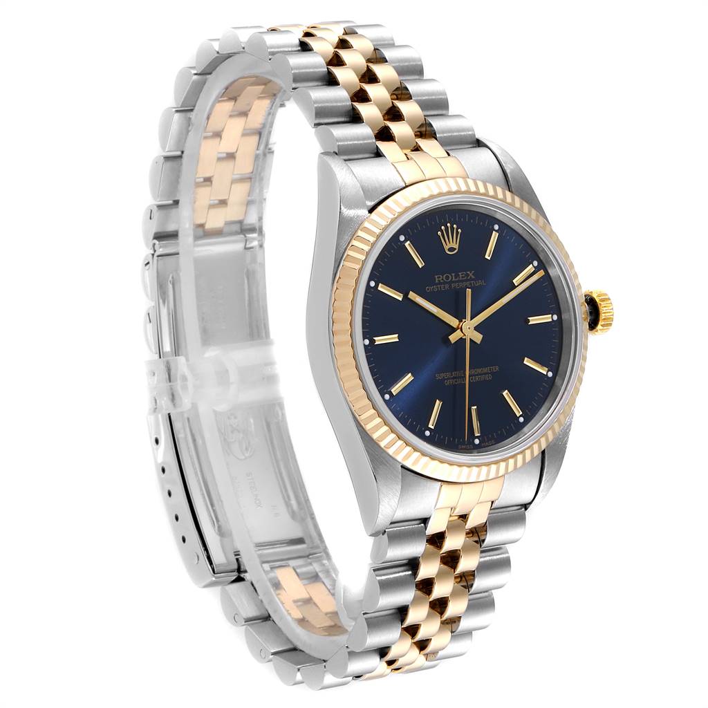 The Rolex Oyster Perpetual 14233 Men's Steel and Gold (two tone) Blue Dial 14233 Men's Steel and Gold (two tone) Blue Dial watch is shown at an angle highlighting the blue dial, gold bezel, and two-tone bracelet.