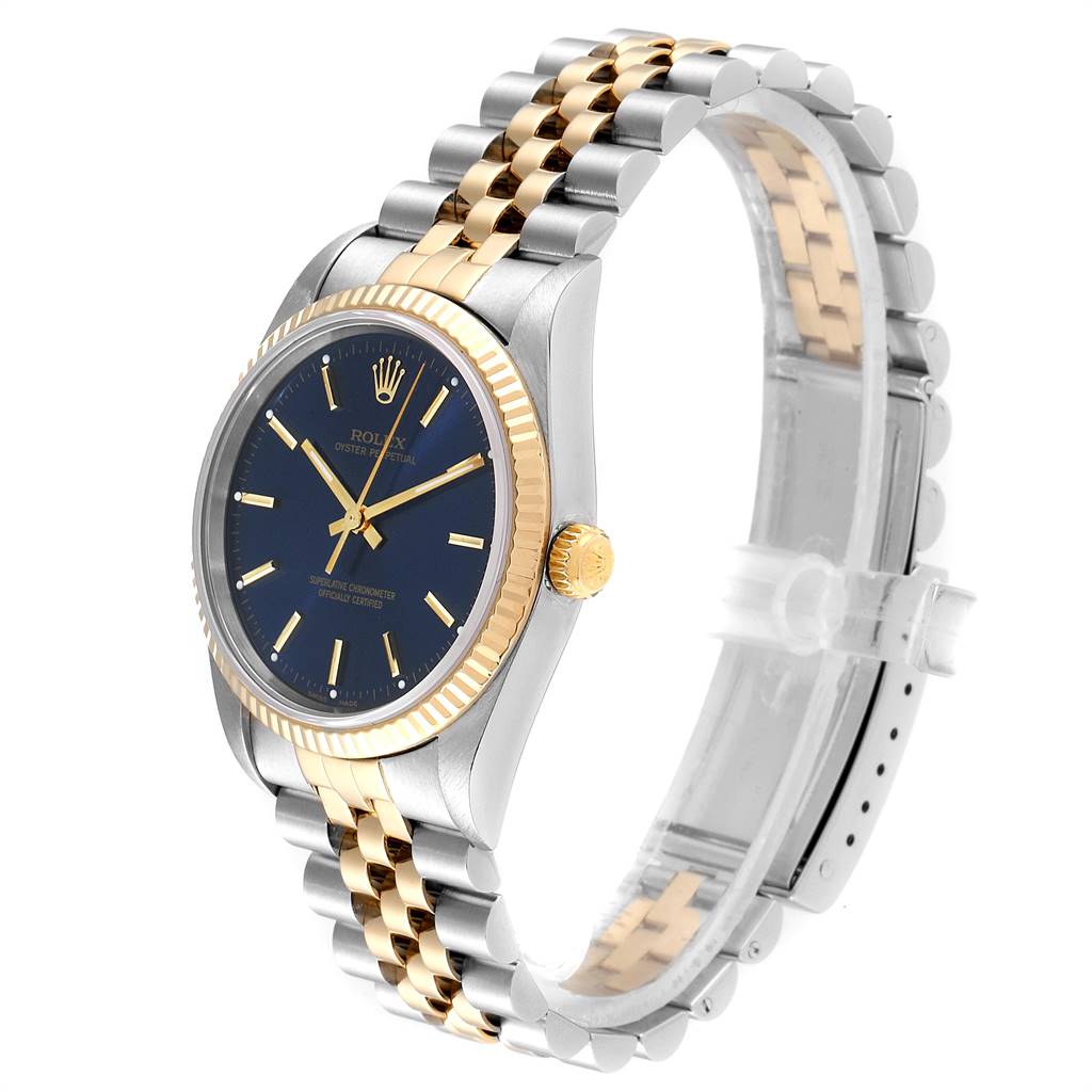 The image shows a side angle of a Rolex Oyster Perpetual 14233 Men's Steel and Gold (two tone) Blue Dial 14233 Men's Steel and Gold (two tone) Blue Dial watch, highlighting its two-tone metal bracelet, bezel, and blue dial.
