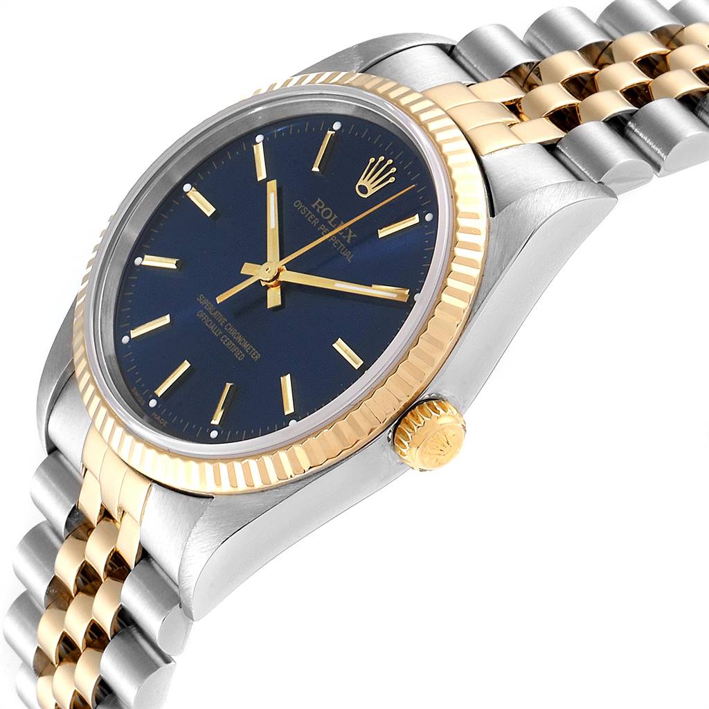 The Rolex Oyster Perpetual 14233 Men's Steel and Gold (two tone) Blue Dial 14233 Men's Steel and Gold (two tone) Blue Dial watch is shown at an angle highlighting the dial, crown, and bracelet.