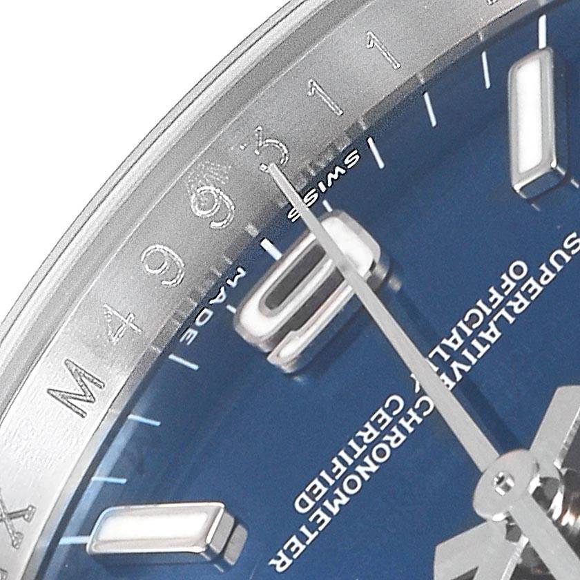 This is a close-up of the Rolex Oyster Perpetual 116000 Men's Stainless Steel Blue Dial 116000 Men's Stainless Steel Blue Dial watch, showing the dial, hands, and part of the bezel.