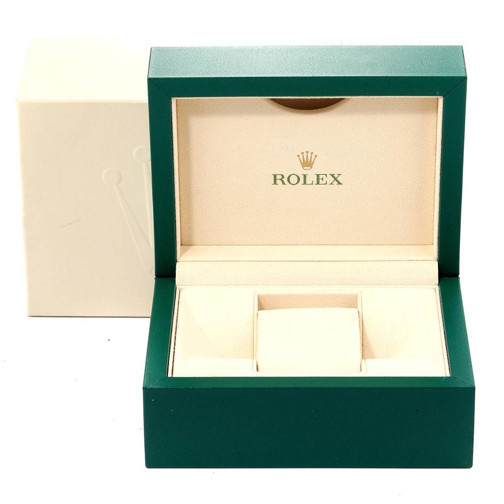This image shows an open Rolex box designed to hold an Oyster Perpetual model watch, featuring green and beige tones.