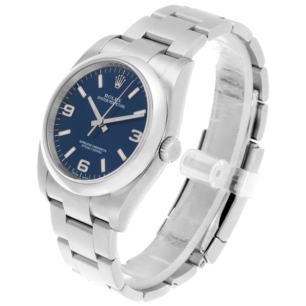 This image shows a Rolex Oyster Perpetual 116000 Men's Stainless Steel Blue Dial 116000 Men's Stainless Steel Blue Dial watch from an angled side view, displaying the bracelet, case, and dial.