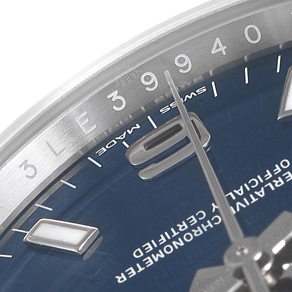 This is a close-up of the face of a Rolex Oyster Perpetual 114200 Men's Stainless Steel Blue Dial 114200 Men's Stainless Steel Blue Dial watch, showing the minute markers and part of the dial with the numeral 9.