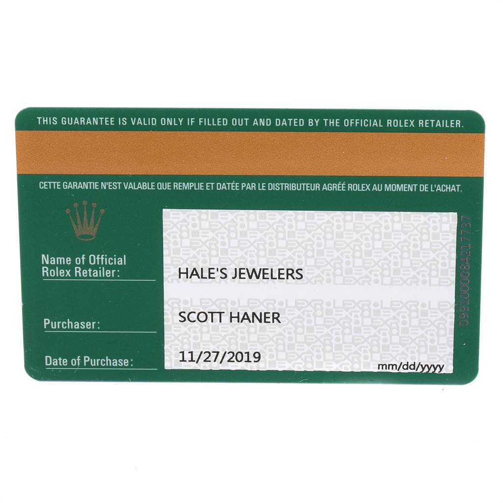 The image shows a filled and dated warranty card for a Rolex Oyster Perpetual 114200 Men's Stainless Steel Blue Dial 114200 Men's Stainless Steel Blue Dial watch issued by an official retailer.