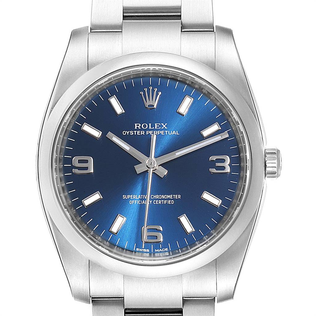 The image shows a front view of the Rolex Oyster Perpetual 114200 Men's Stainless Steel Blue Dial 114200 Men's Stainless Steel Blue Dial watch, featuring its dial, hands, bezel, and part of the bracelet.