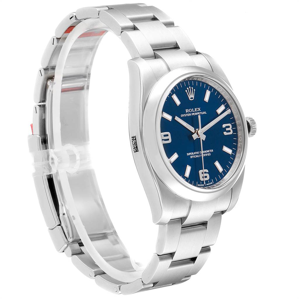 The image shows a Rolex Oyster Perpetual 114200 Men's Stainless Steel Blue Dial 114200 Men's Stainless Steel Blue Dial watch from a side angle, featuring the dial, bezel, case, and part of the bracelet.