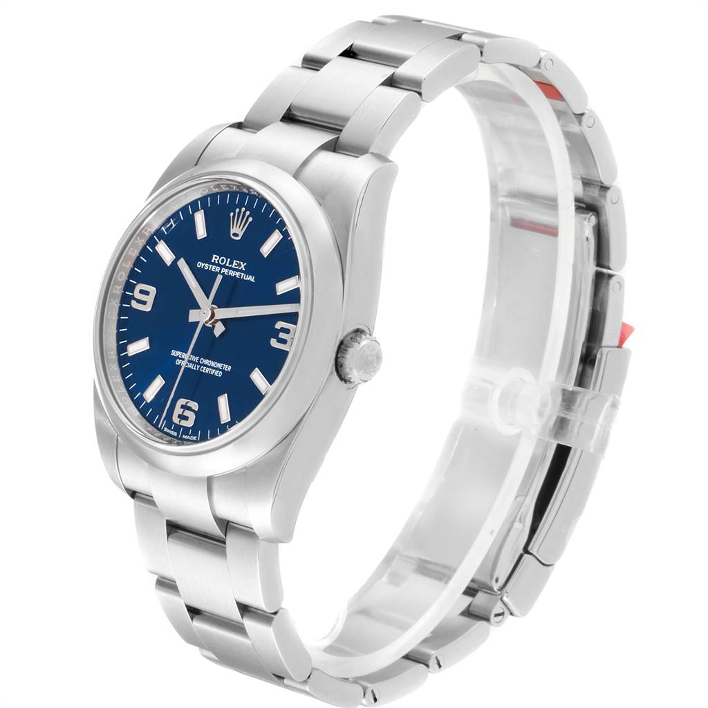 The Rolex Oyster Perpetual 114200 Men's Stainless Steel Blue Dial 114200 Men's Stainless Steel Blue Dial watch is shown at a slight angle, displaying its blue dial, case, bracelet, and clasp.