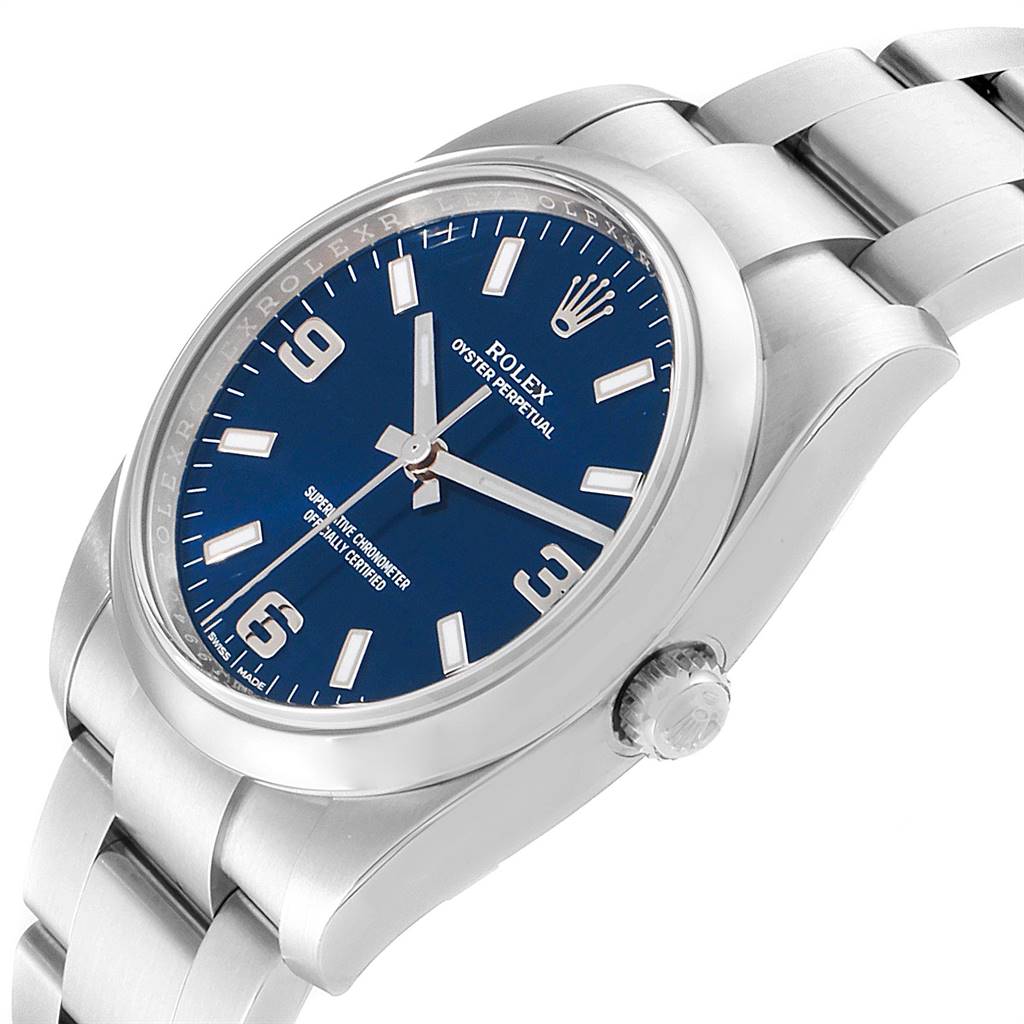 This image shows a Rolex Oyster Perpetual 114200 Men's Stainless Steel Blue Dial 114200 Men's Stainless Steel Blue Dial watch from a slightly tilted angle, highlighting the dial, crown, and bracelet.