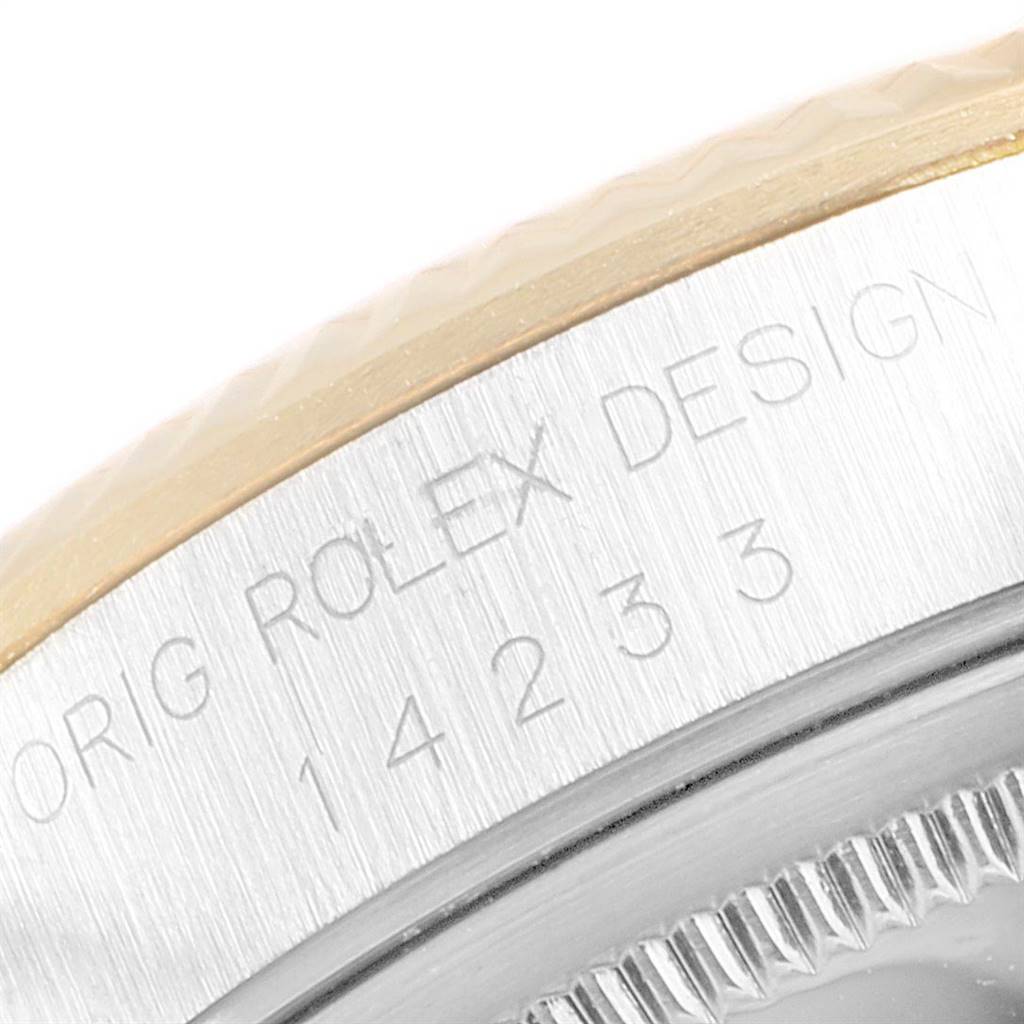 This image shows a close-up of the side of the case and part of the bezel of a Rolex Oyster Perpetual 14233 Men
s Steel and Gold (two tone) White Dial 14233 Men
s Steel and Gold (two tone) White Dial watch.