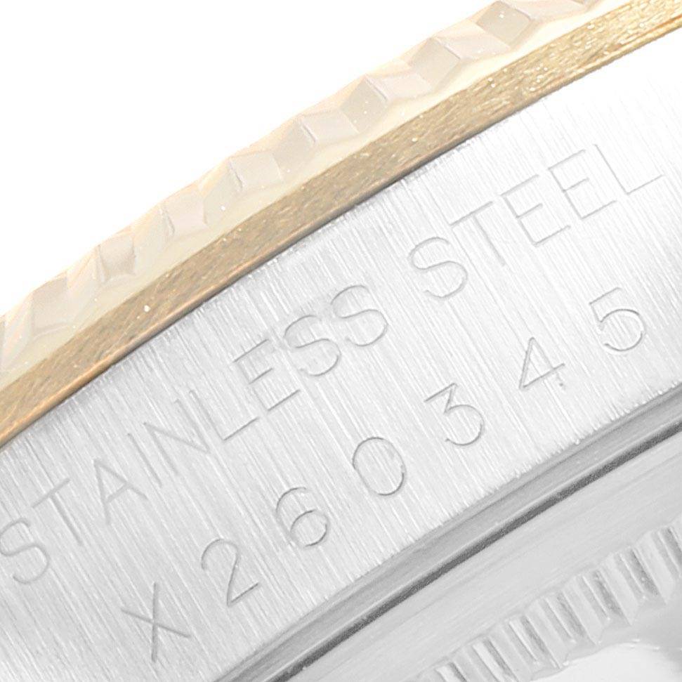 This close-up image shows the side and bezel of a Rolex Oyster Perpetual 14233 Men
s Steel and Gold (two tone) White Dial 14233 Men
s Steel and Gold (two tone) White Dial watch, highlighting the "Stainless Steel" engraving and serial number.