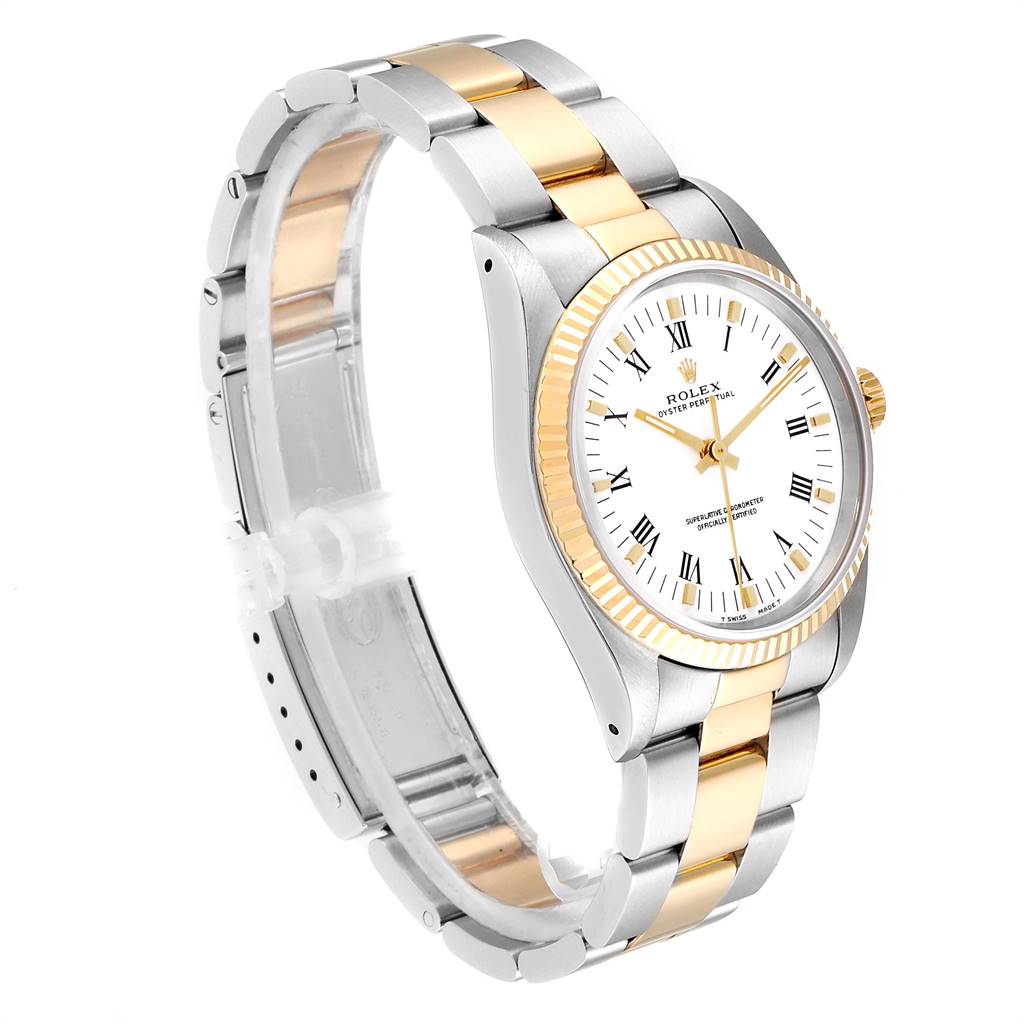 The Rolex Oyster Perpetual 14233 Men
s Steel and Gold (two tone) White Dial 14233 Men
s Steel and Gold (two tone) White Dial watch is shown at a three-quarter angle, highlighting its two-tone bracelet, fluted bezel, and white dial.