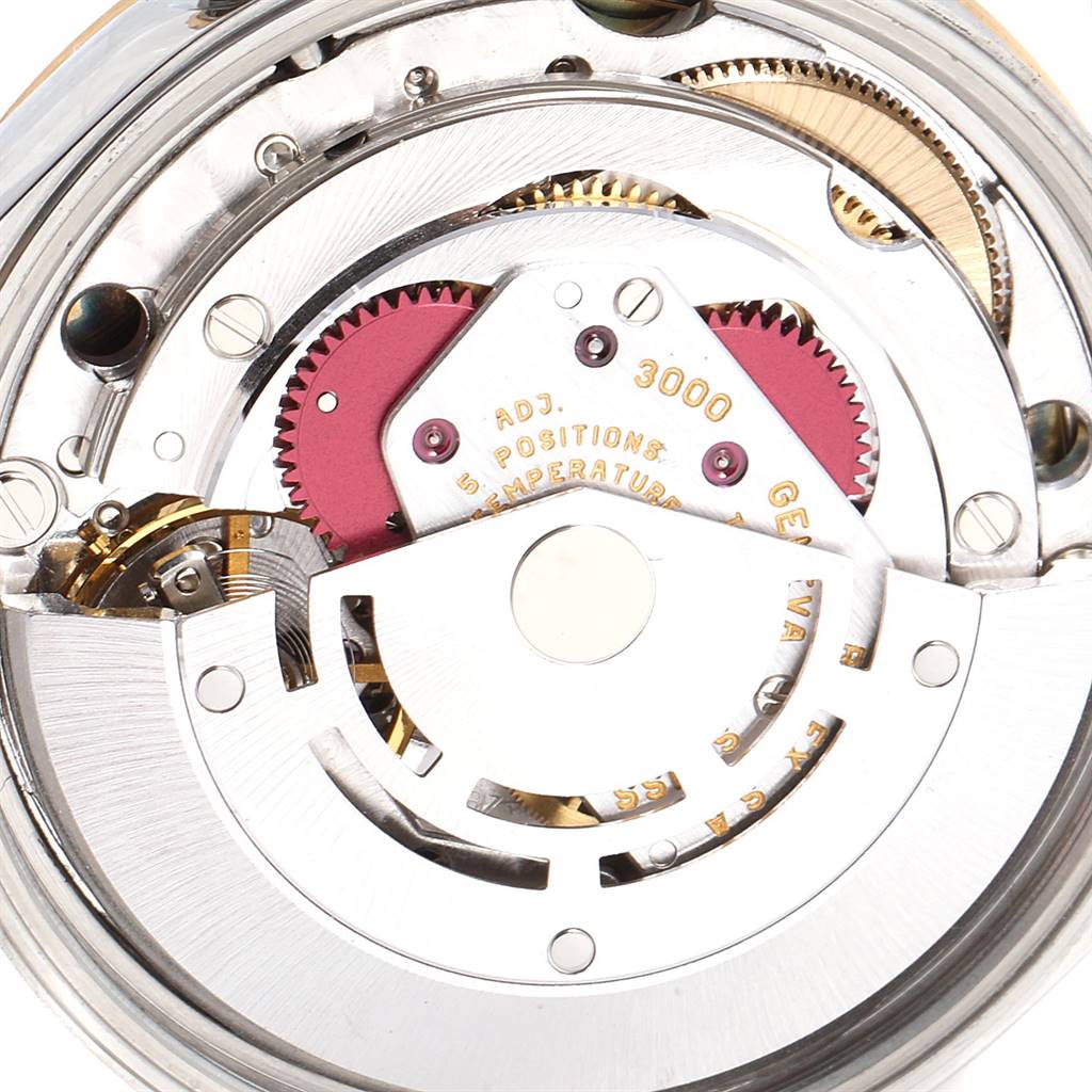 The image shows the internal mechanism of a Rolex Oyster Perpetual 14233 Men
s Steel and Gold (two tone) Champagne Dial 14233 Men
s Steel and Gold (two tone) Champagne Dial watch, viewed from the back with gears and components visible.