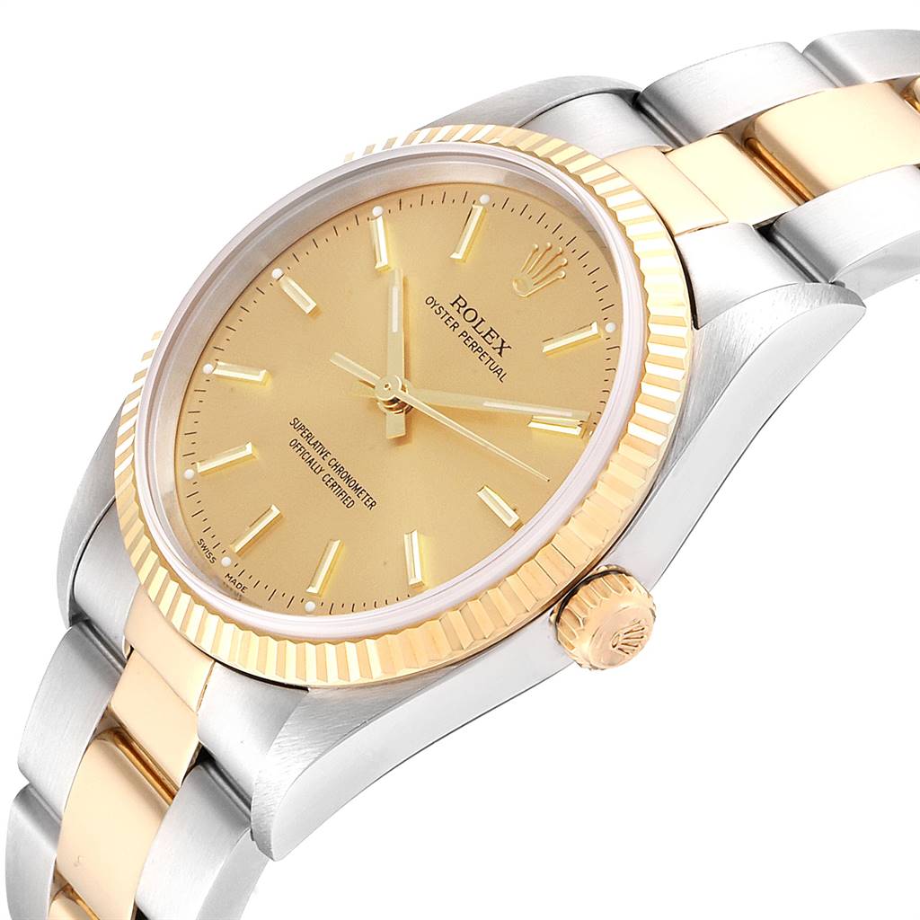 The Rolex Oyster Perpetual 14233 Men
s Steel and Gold (two tone) Champagne Dial 14233 Men
s Steel and Gold (two tone) Champagne Dial watch is shown at a slight angle displaying its gold dial, fluted bezel, and two-tone metal bracelet.