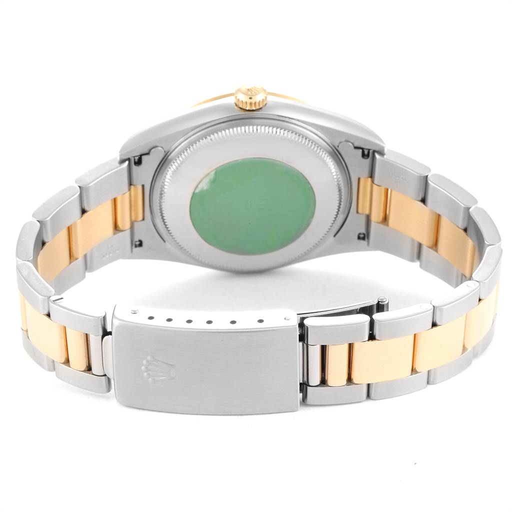 This image shows the back view of a Rolex Oyster Perpetual 14233 Men
s Steel and Gold (two tone) Champagne Dial 14233 Men
s Steel and Gold (two tone) Champagne Dial watch, highlighting its clasp, bracelet, and case back.