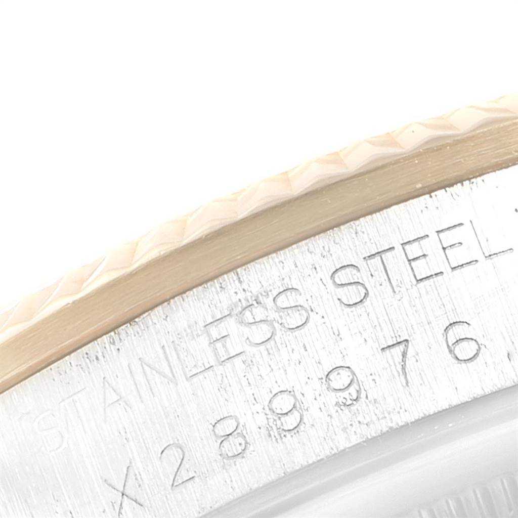 The close-up image shows the side of the bezel and part of the case of the Rolex Oyster Perpetual 14233 Men
s Steel and Gold (two tone) Champagne Dial 14233 Men
s Steel and Gold (two tone) Champagne Dial, highlighting engravings and texture details.