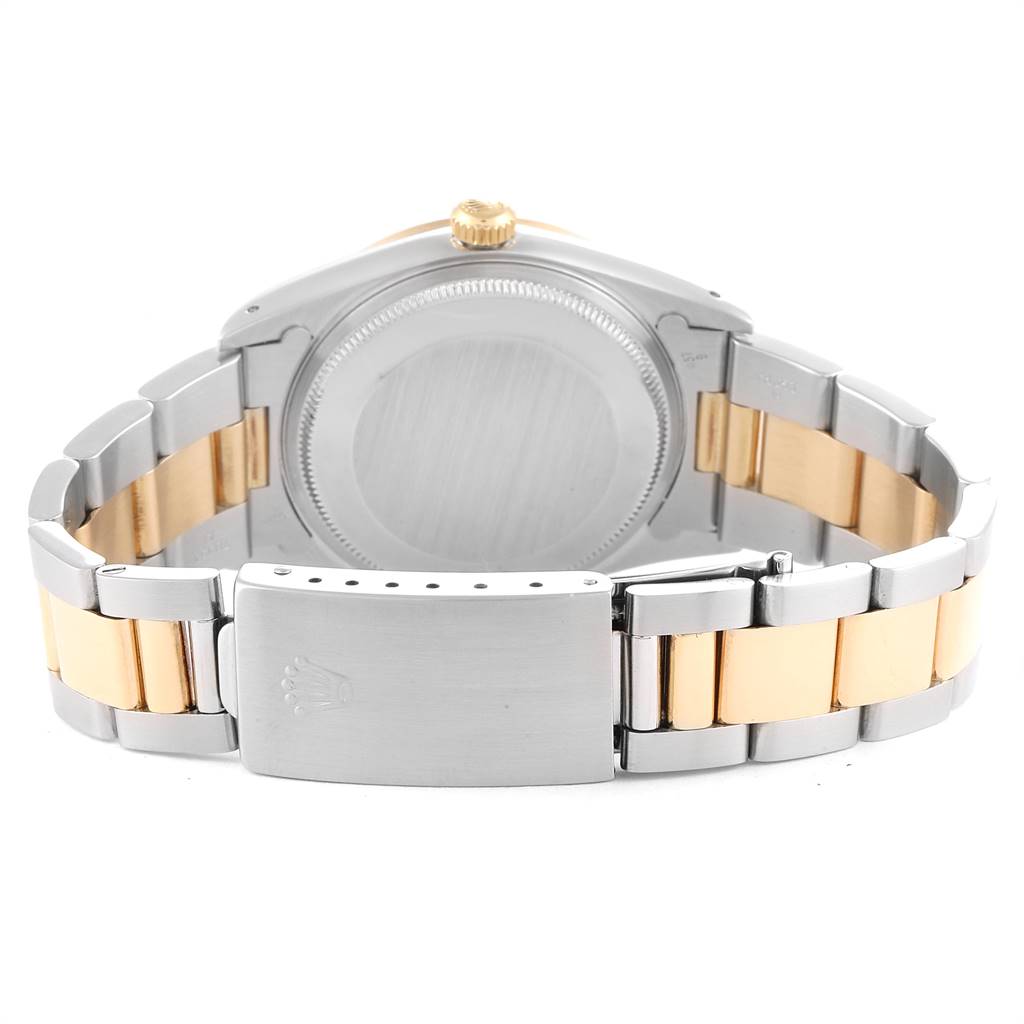 This image shows the back case and bracelet of a Rolex Oyster Perpetual 14233 Men
s Steel and Gold (two tone) Champagne Dial 14233 Men
s Steel and Gold (two tone) Champagne Dial watch, focusing on the clasp and bi-color metal links.