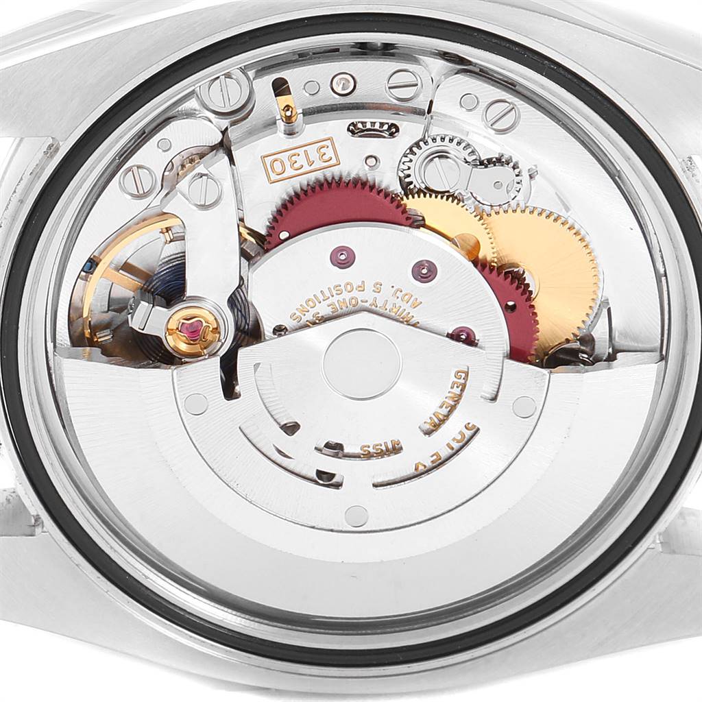 The image shows the internal mechanics and movement of a Rolex Oyster Perpetual 116000 Men
s Stainless Steel Champagne Dial 116000 Men
s Stainless Steel Champagne Dial watch from the back view.