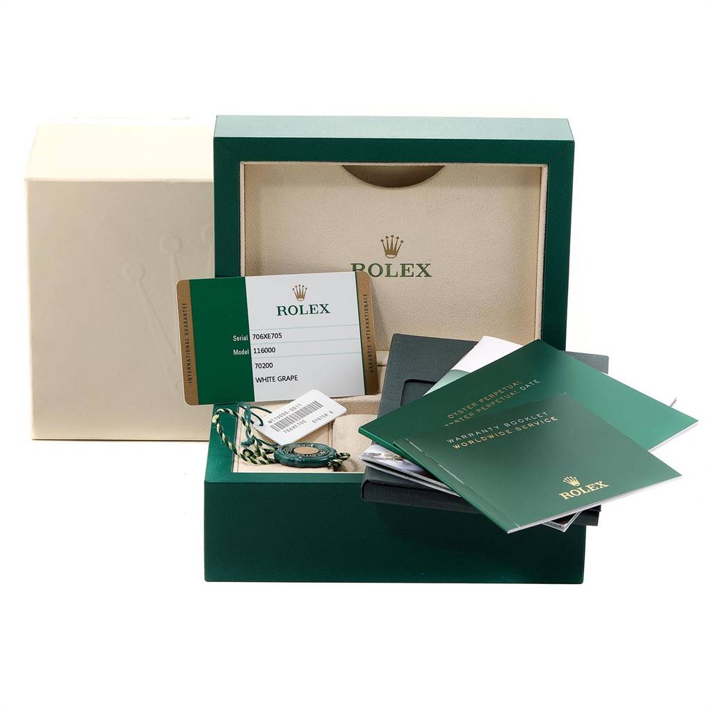 The image shows the accessories and packaging for a Rolex Oyster Perpetual 116000 Men
s Stainless Steel Champagne Dial 116000 Men
s Stainless Steel Champagne Dial, including manuals, tags, warranty card, and box.