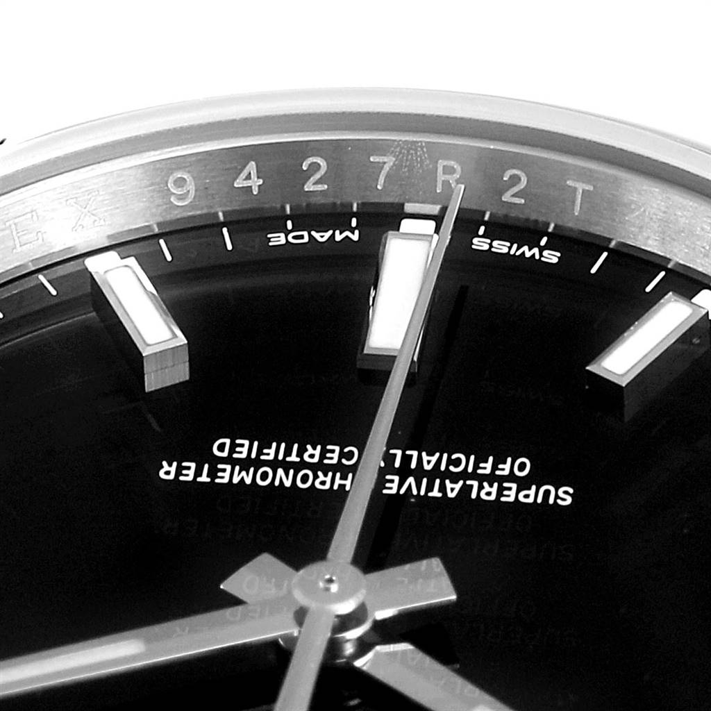 The image shows a close-up angle of the dial and hands of the Rolex Oyster Perpetual 114200 Men's Stainless Steel Black Dial 114200 Men's Stainless Steel Black Dial watch.