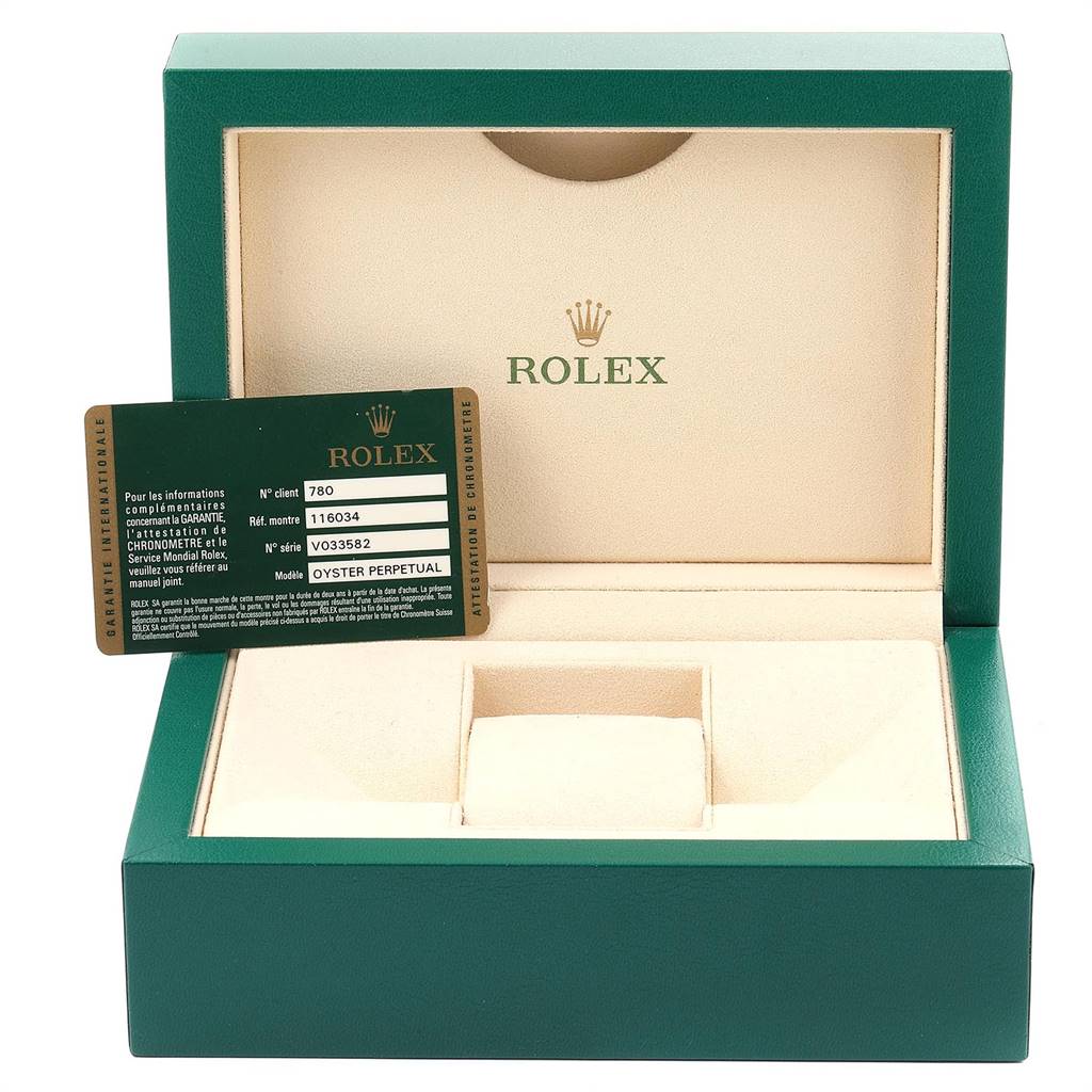 The image shows an open Rolex Oyster Perpetual 116034 Men's Stainless Steel Black Dial 116034 Men's Stainless Steel Black Dial watch box and a warranty card angled slightly to the left.