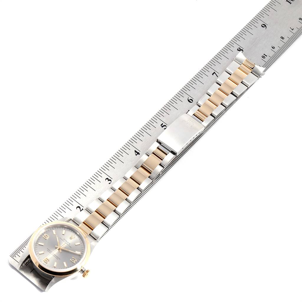 The image shows a Rolex Oyster Perpetual 14203 Men's Steel and Gold (two tone) Grey Dial 14203 Men's Steel and Gold (two tone) Grey Dial watch with a two-tone bracelet, displayed next to a ruler for measurement.