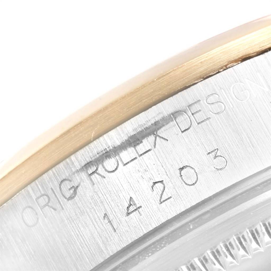 This image shows a close-up of the case back engraving on the Rolex Oyster Perpetual 14203 Men's Steel and Gold (two tone) Grey Dial 14203 Men's Steel and Gold (two tone) Grey Dial watch model.