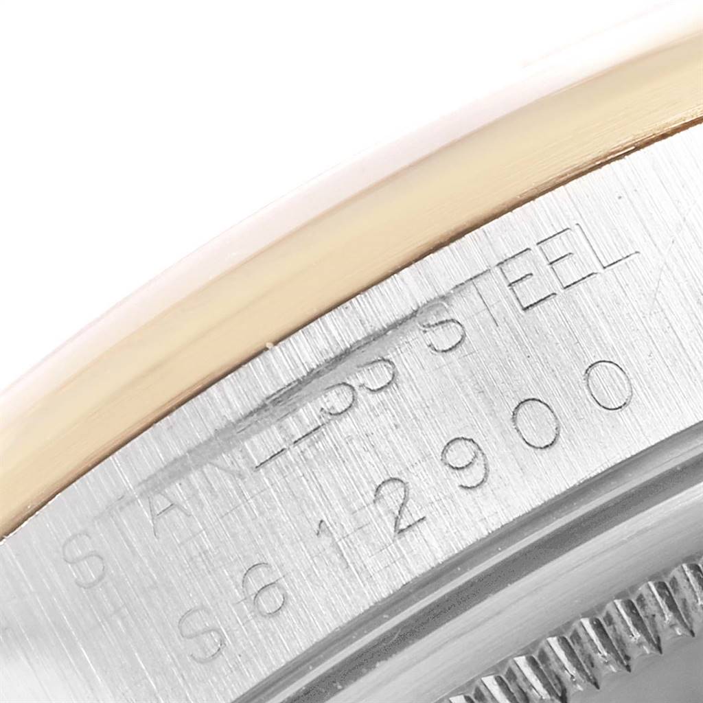 This image shows a close-up of the side of the case and bezel of a Rolex Oyster Perpetual 14203 Men's Steel and Gold (two tone) Grey Dial 14203 Men's Steel and Gold (two tone) Grey Dial watch, displaying its stainless steel material.