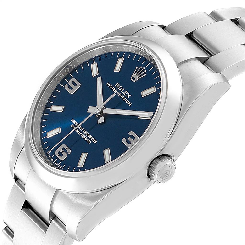 The image shows a Rolex Oyster Perpetual 114200 Men's Stainless Steel Blue Dial 114200 Men's Stainless Steel Blue Dial watch angled to display its face, bezel, crown, and bracelet.