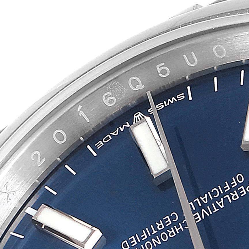 Close-up of a Rolex Datejust 126200 Men's Stainless Steel Blue Dial 126200 Men's Stainless Steel Blue Dial watch showing part of the dial, bezel, and hour markers.
