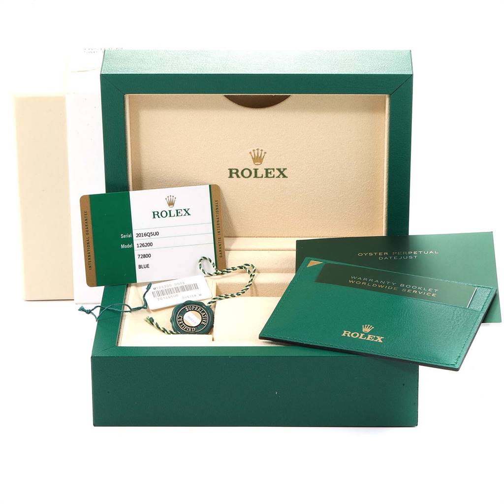 The image shows the packaging, warranty booklet, and tags for a Rolex Datejust 126200 Men's Stainless Steel Blue Dial 126200 Men's Stainless Steel Blue Dial model.