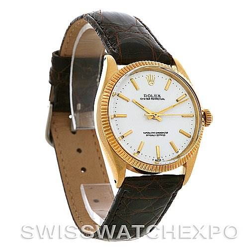 The image shows a Rolex Oyster Perpetual Men
s Yellow Gold White Dial Men
s Yellow Gold White Dial watch with a leather strap, gold case, and white dial, viewed at a front diagonal angle.