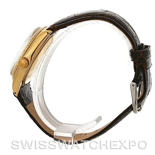 Side view of a Rolex Oyster Perpetual Men
s Yellow Gold White Dial Men
s Yellow Gold White Dial watch showing the gold case, crown, and brown leather strap.